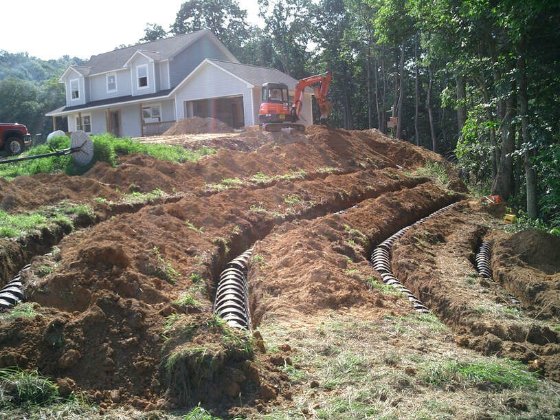 House with exposed soil and septic field drain lines