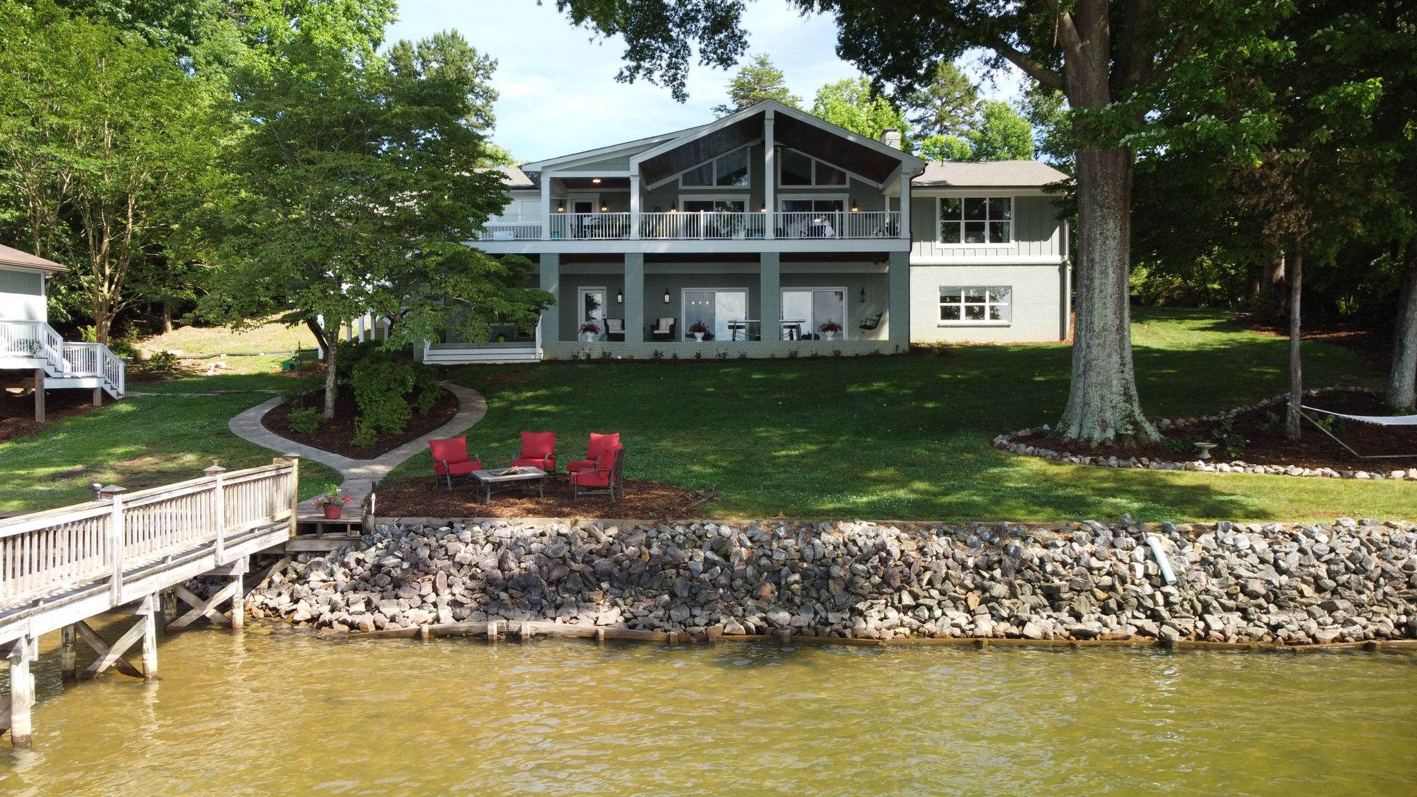Before After Renovation Lakefront Backyard Outdoor Firepit Hanging Bridge Covered Patio Covered Porch