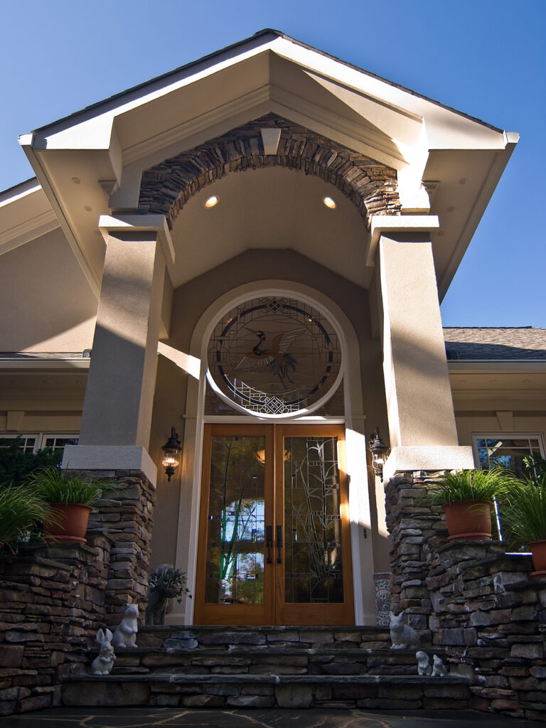 Stacked Stone Arched Stained Glass Entryway